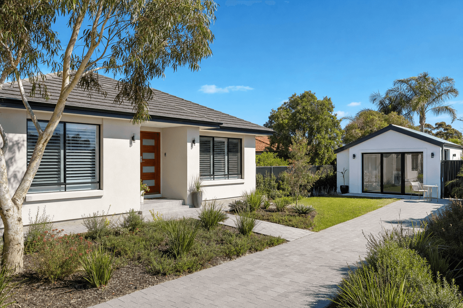 Modern granny flat in a sunny Australian backyard with native garden
